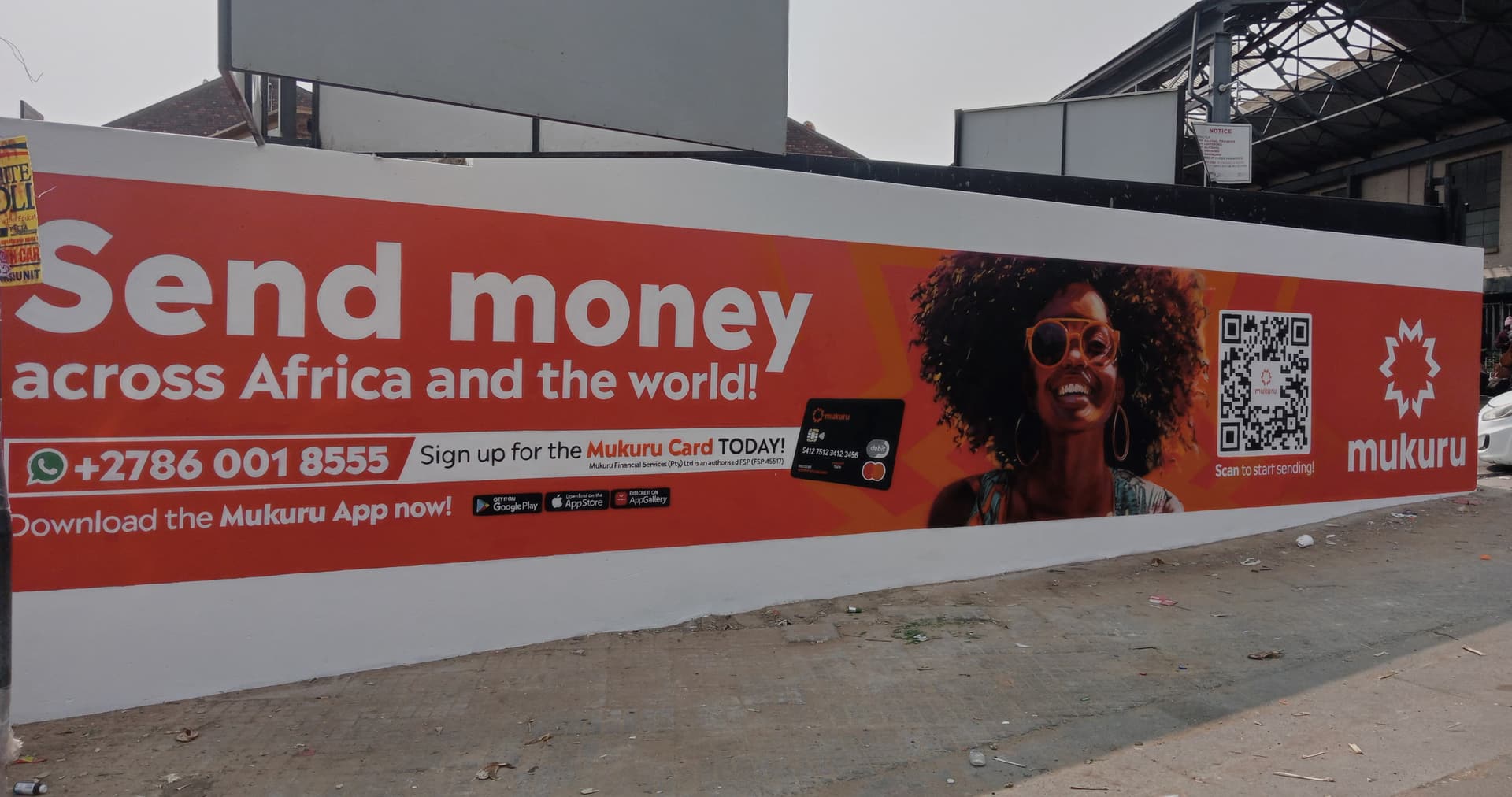 Orange Mukuru "Send money across Africa and the world" mural along a street wall